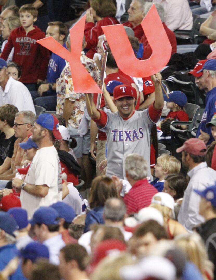 Texas Rangers fans cheer after Texas Rangers starting pitcher Yu Darvish (11) finished the...