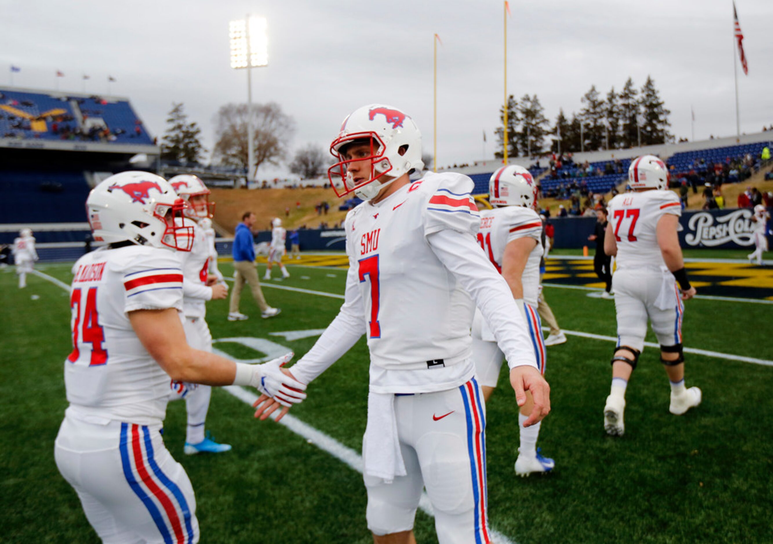 Southern Methodist Mustangs quarterback Shane Buechele (7) greets his teammates for pregame...