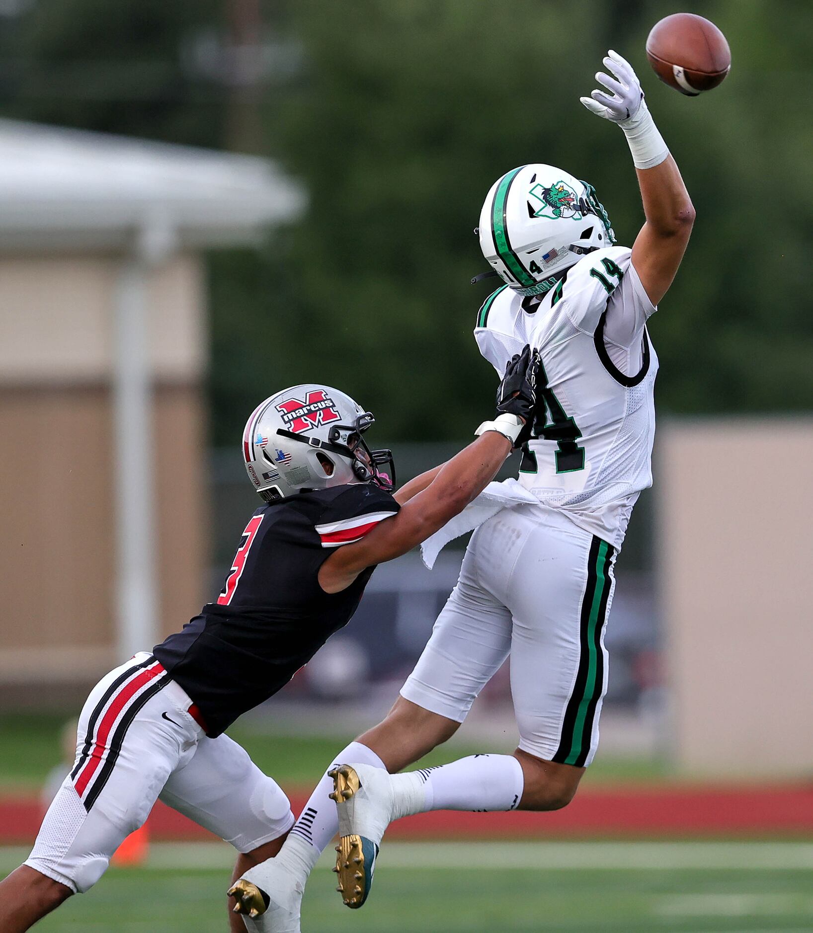 Southlake Carroll wide receiver Clayton Wayland (14) tries to come up with a reception...