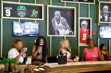 People sit around the bar at NINE Kitchen & Lounge, the first restaurant venture of NFL...
