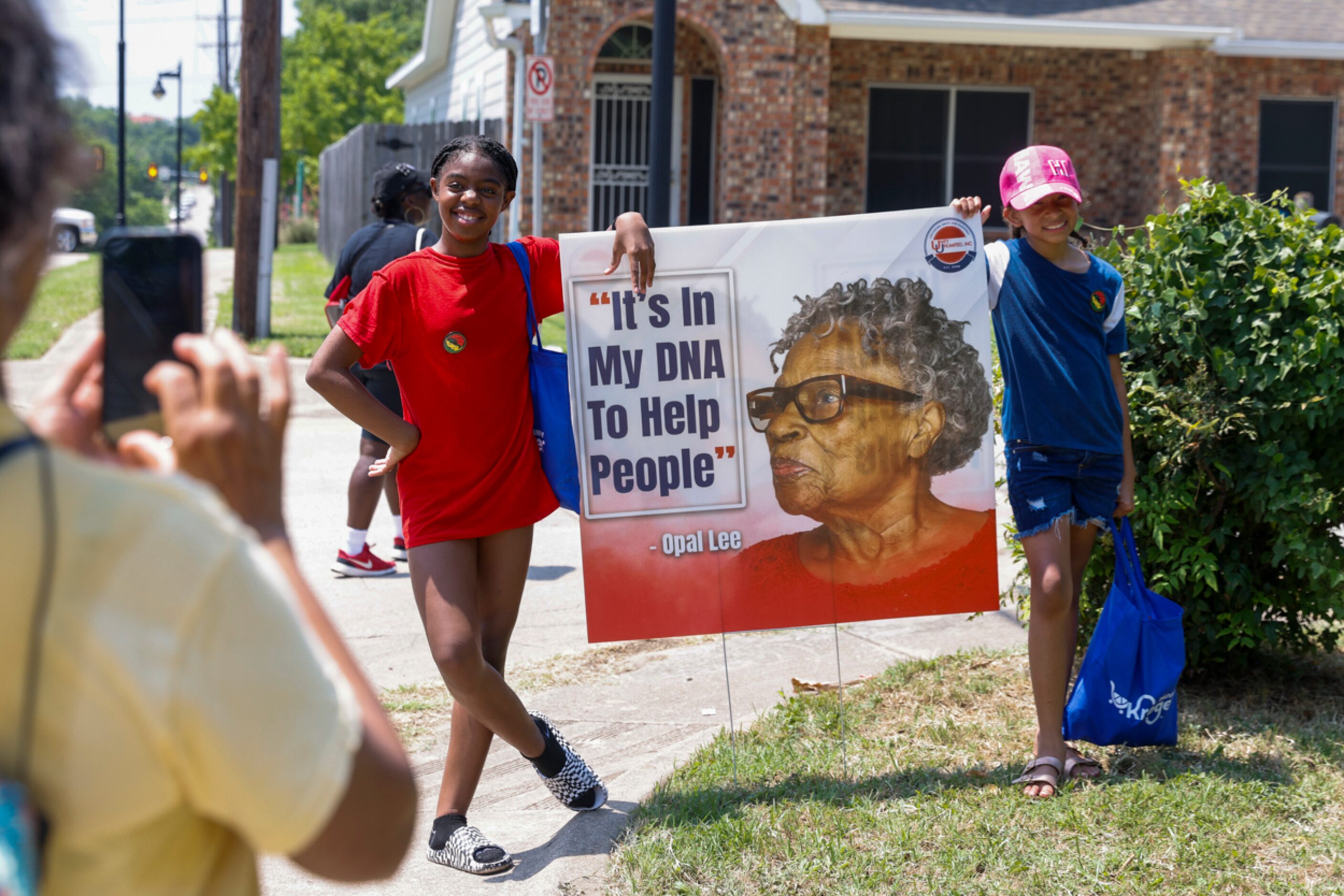 Lena Lee, 5, (left) and Evette Stone, 9, pose for a photo with a sign of Opal Lee during...