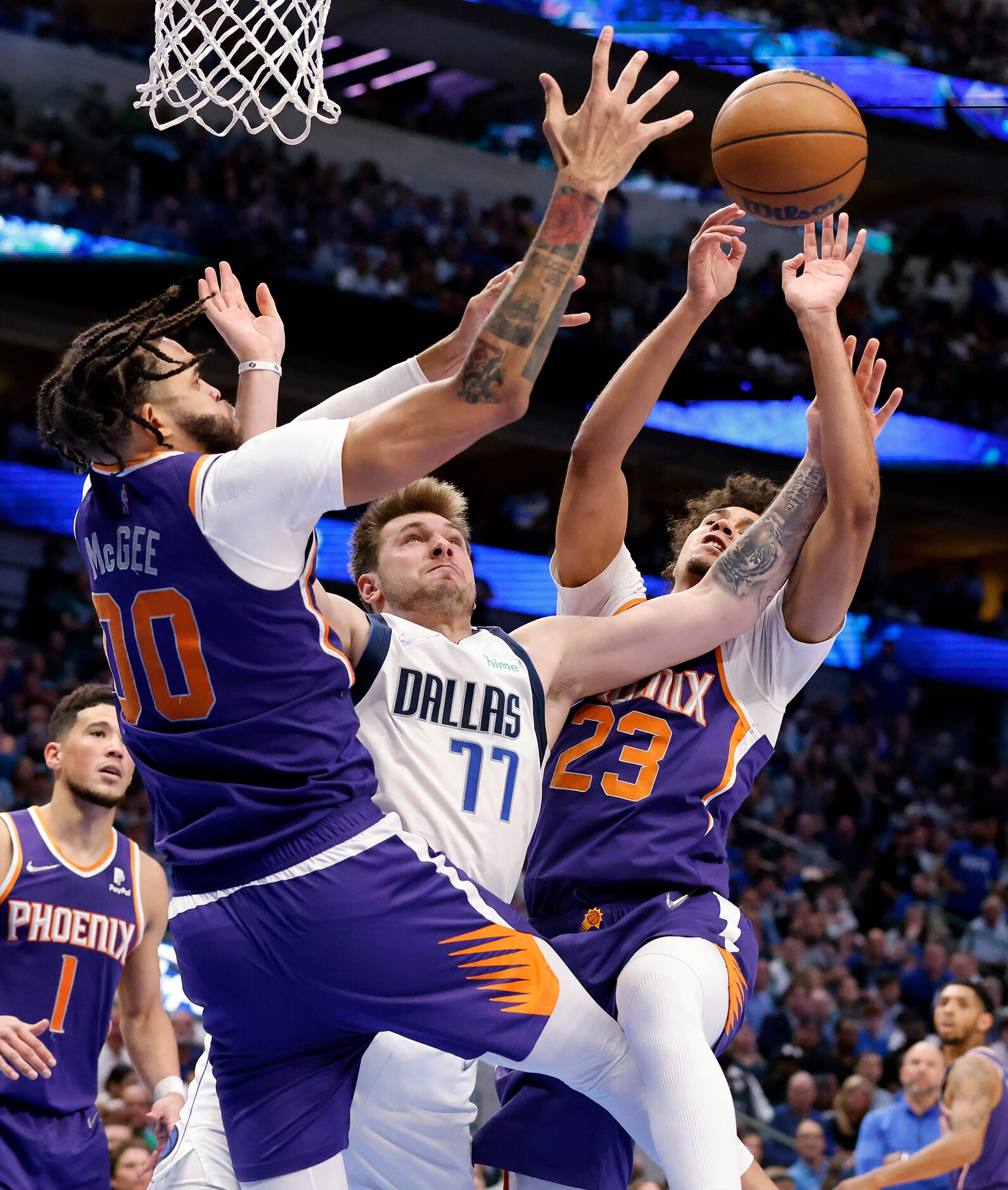 Dallas Mavericks guard Luka Doncic (77) goes up for an offensive rebound and is fouled as he...