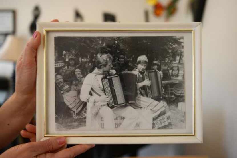 
Elena Fainshtein holds a photo of her and her husband, Gregory, playing together in what is...