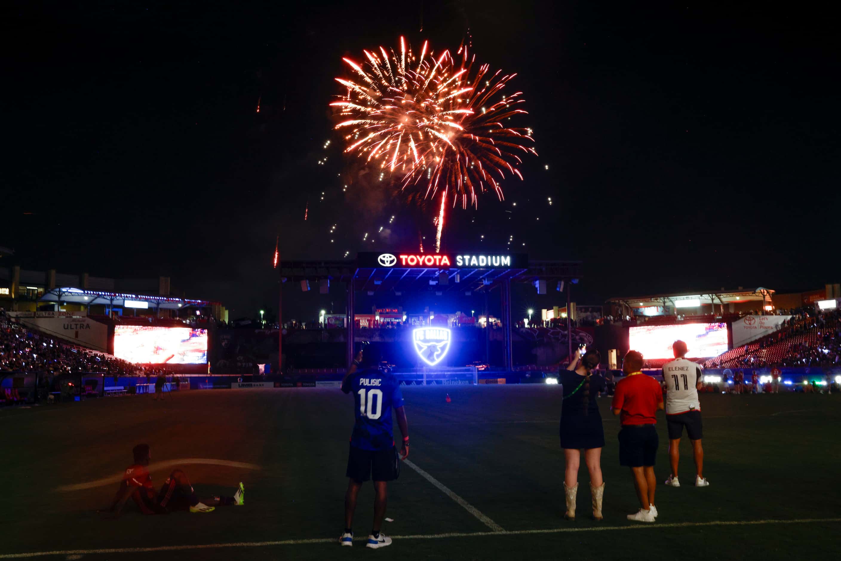 People watch a firework show after a soccer game between FC Dallas and D.C. United at Toyota...