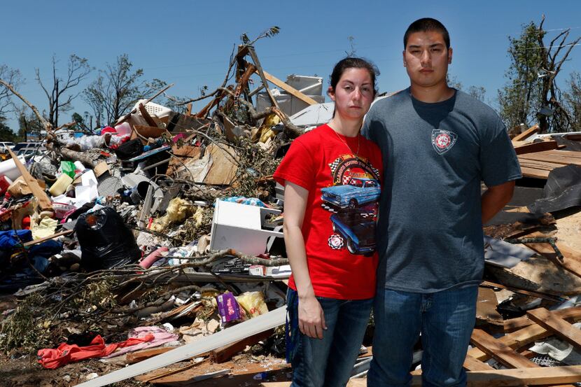 Taylor and Jonathan Beasley pose for a portrait in front of their belongings in Emory, Texas...