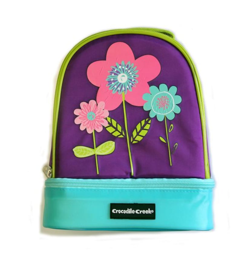 
A daisy-adorned lunch box’s extra lining keeps food fresh and crush-free. An extra storage...