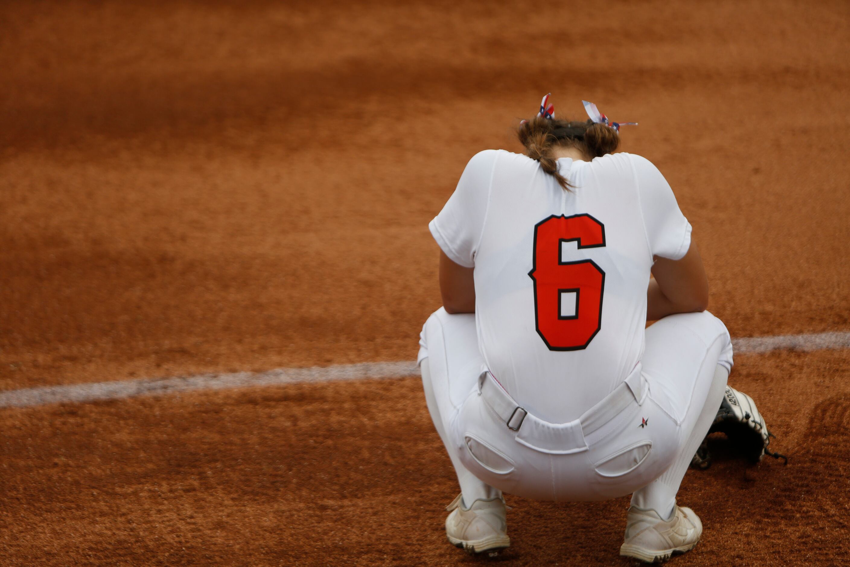 Aledo's Caitlin Beaty (6) pauses near 1st base before the start of their state championship...