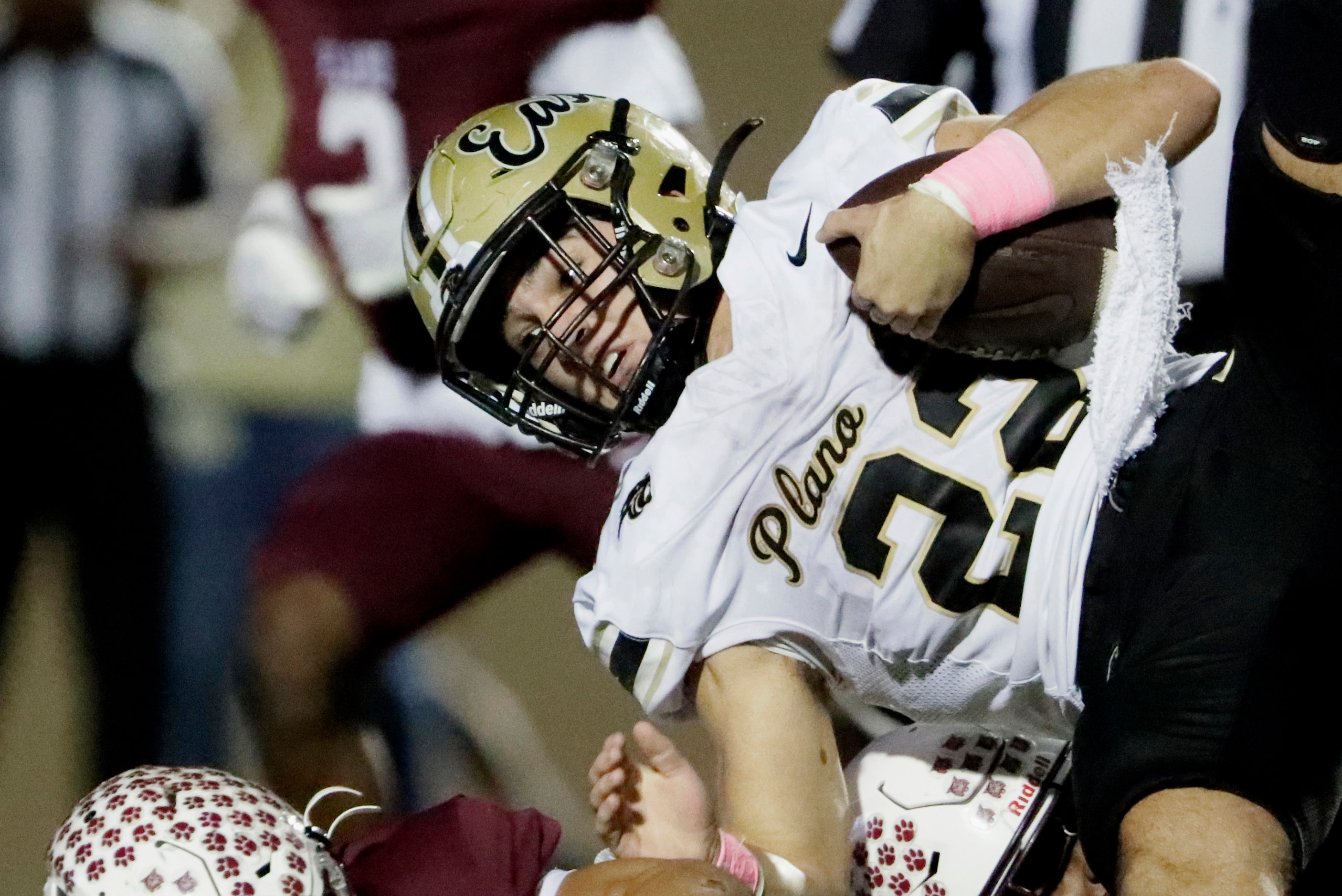 Plano East High School running back Travis Agee (22) is upended during the first half as...