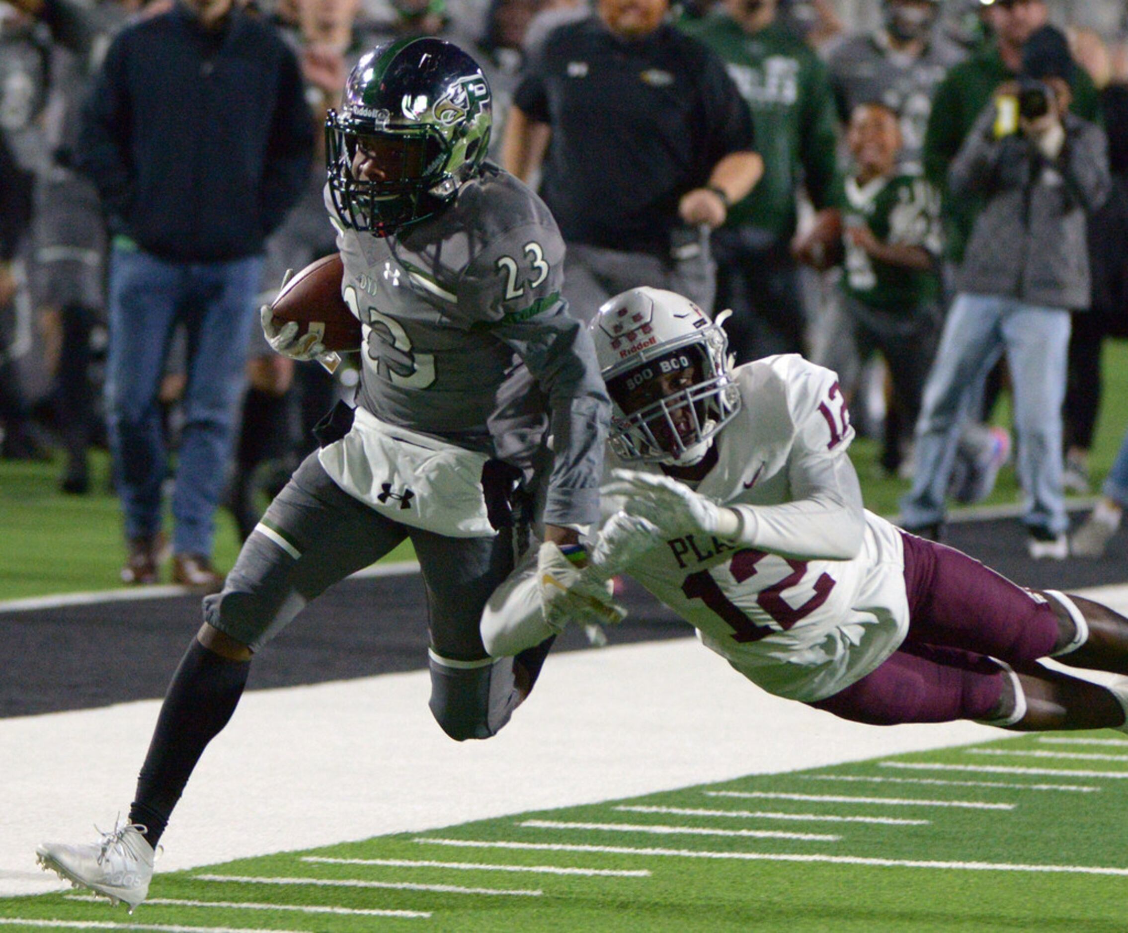 Prosper's Ryan Threat is pushed out of bound by Plano's Trey Ford (12) after a reception in...