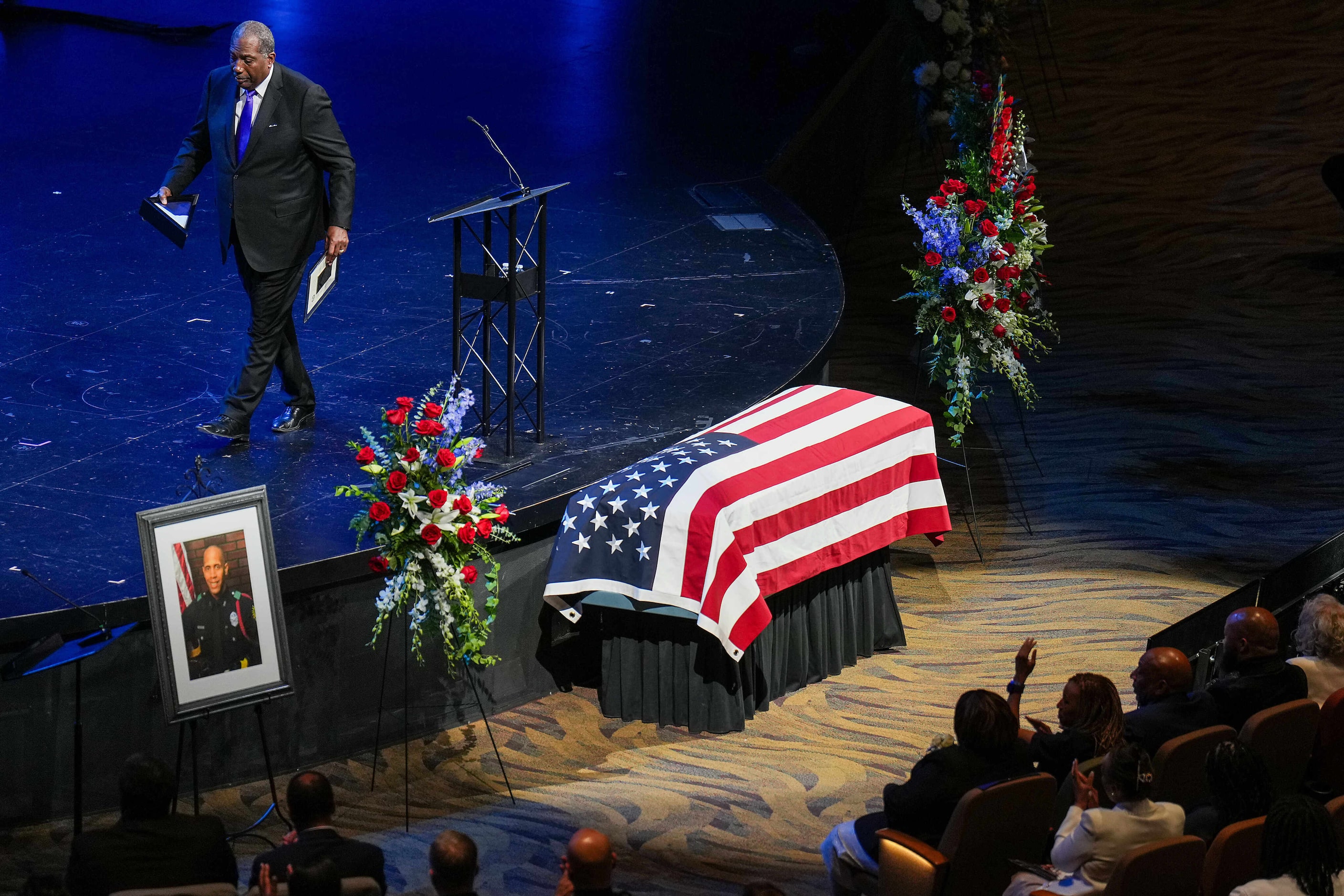 Texas Sen. Royce West walks from the microphone to deliver a flag and state proclamation to...