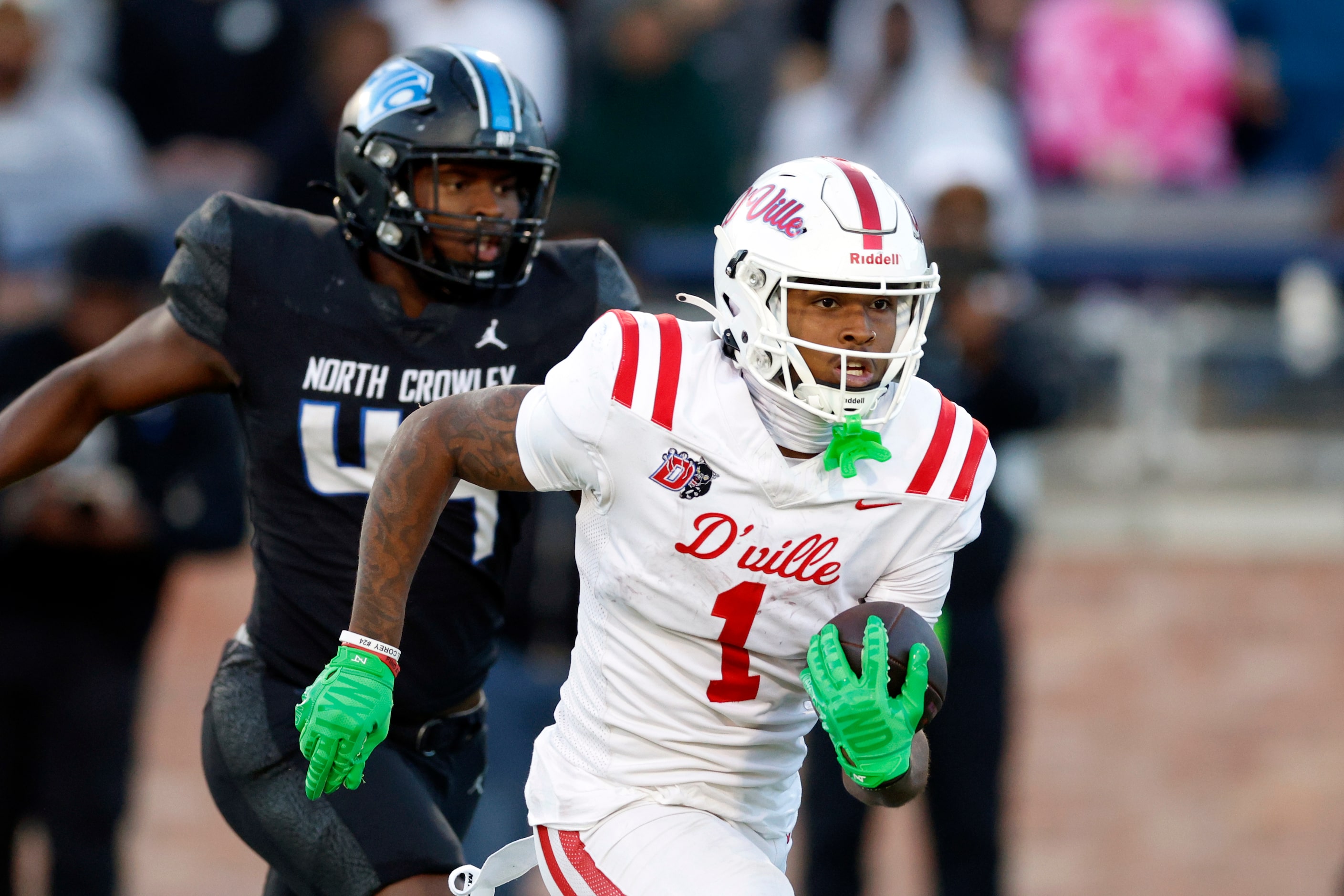 Duncanville wide receiver Dakorien Moore (1) runs the ball ahead of North Crowley linebacker...