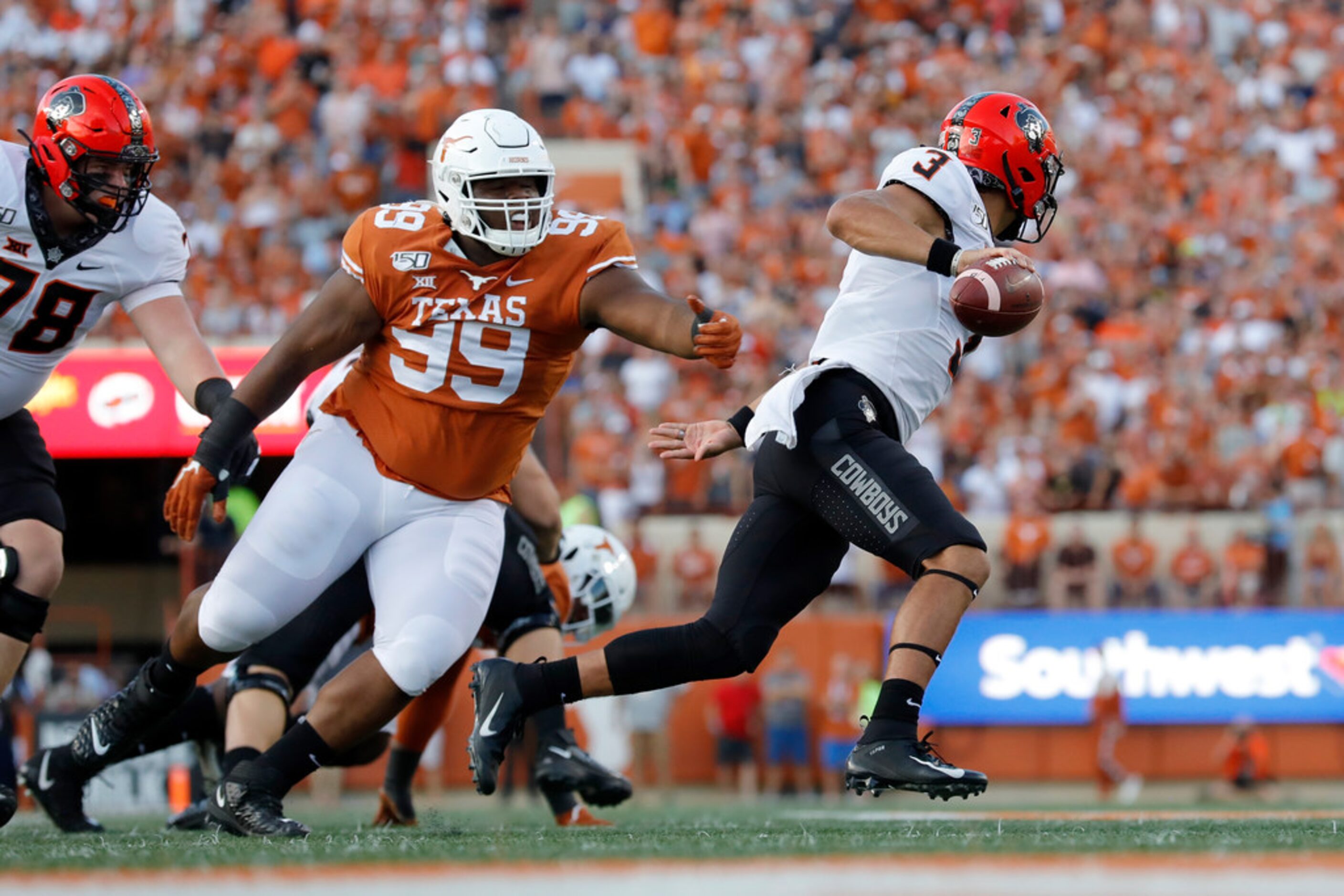 AUSTIN, TX - SEPTEMBER 21:  Spencer Sanders #3 of the Oklahoma State Cowboys avoids pressure...