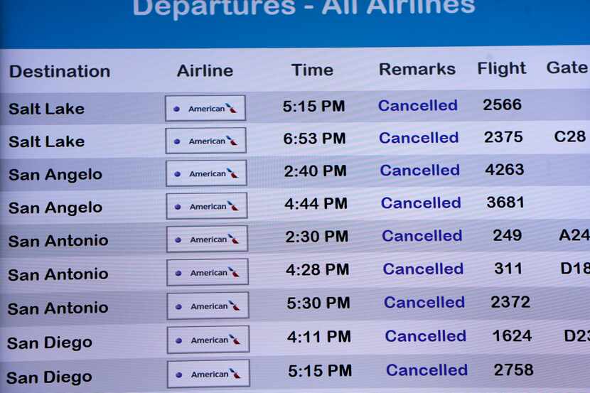 Cancelled flights on the departures screen in terminal C at DFW International Airport on...
