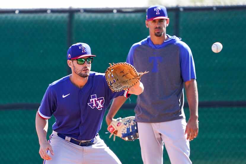 Texas Rangers first basemen Greg Bird and Ronald Guzman participate in a fielding drill...