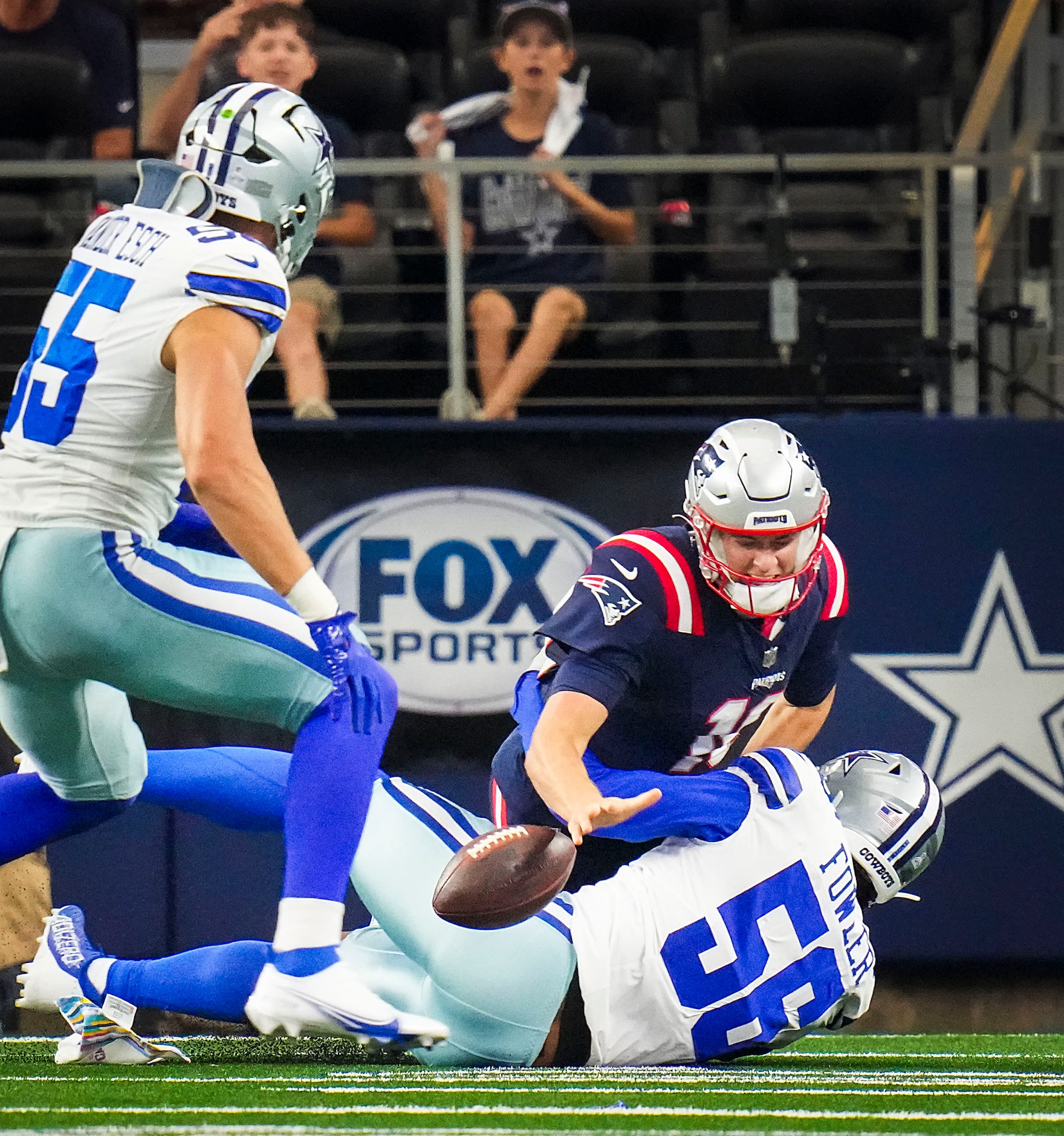 New England Patriots quarterback Mac Jones (10) fumbles as he is hit by Dallas Cowboys...