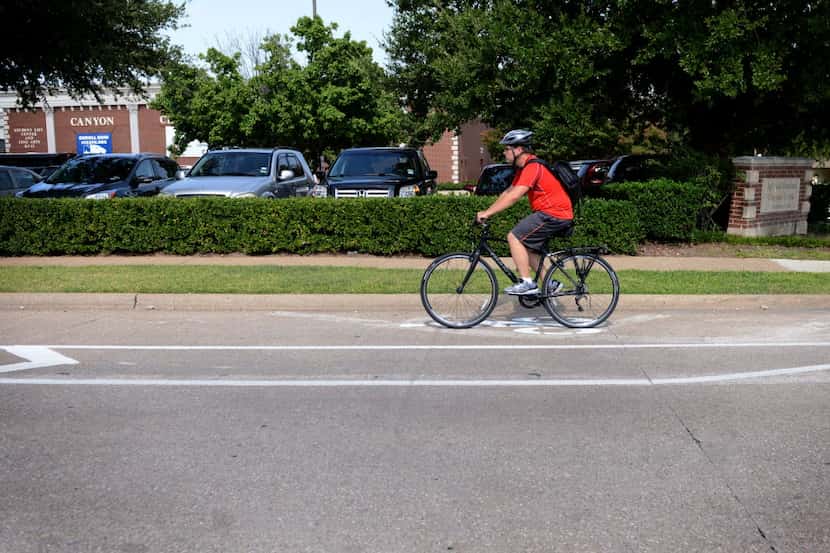  A bicyclist rides on one of Richardson's designated bike lanes
