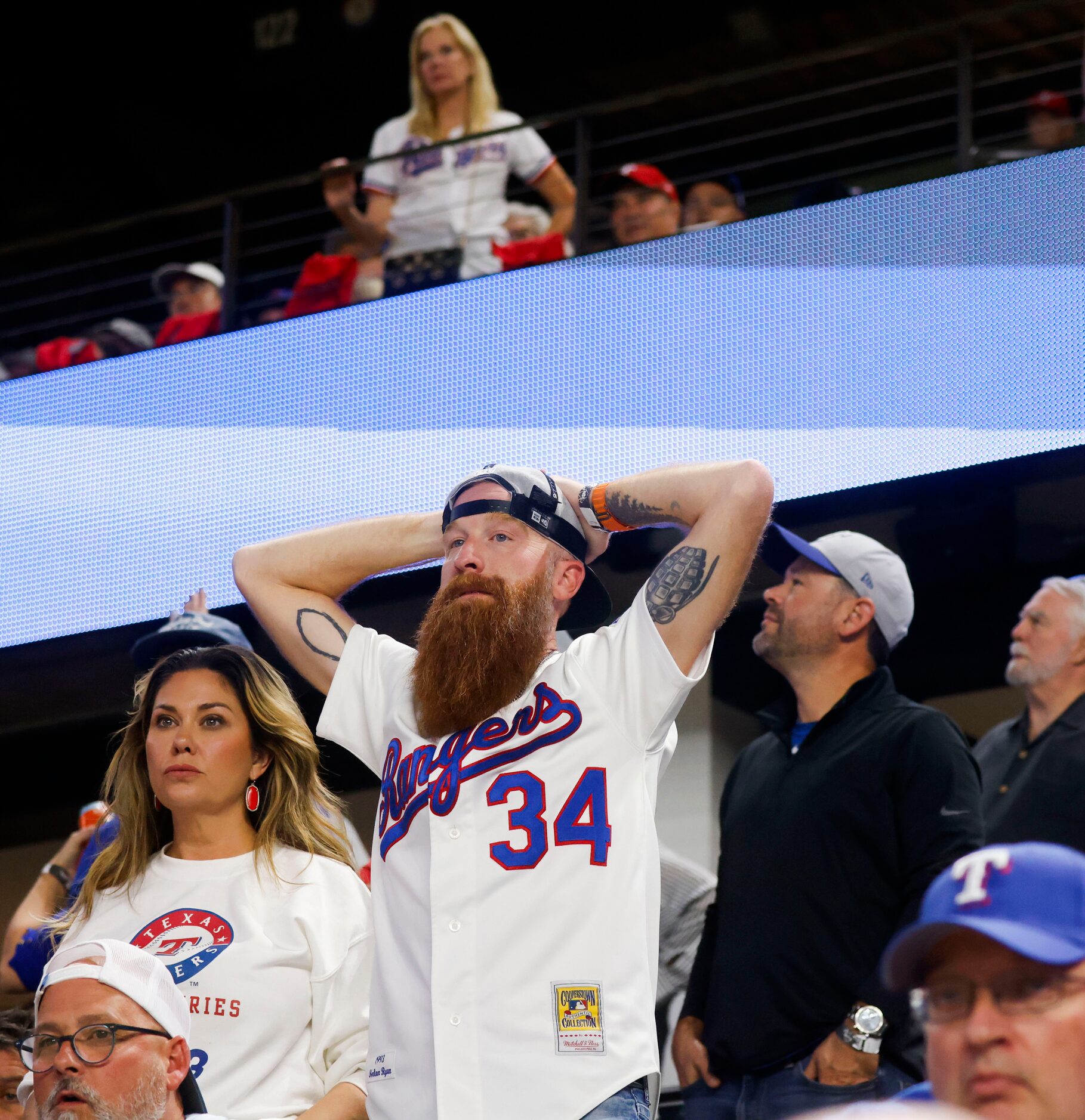 Texas Rangers fans looks dejected after the Arizona Diamondbacks won Game 2 of the World...