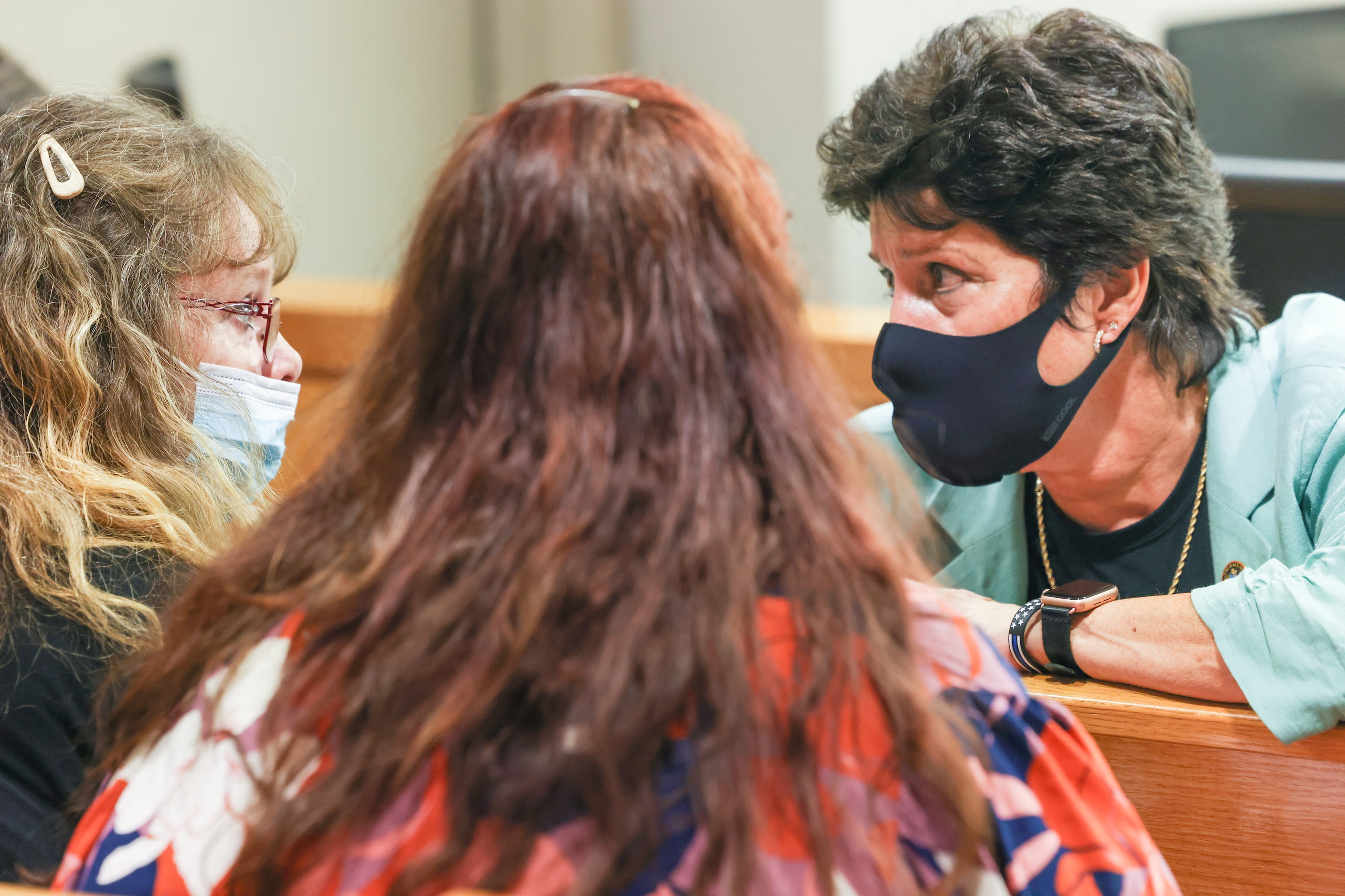 Connie Moggio (left) and Patricia Owens (center) speak with FBI special agent Laurie Gibbs...