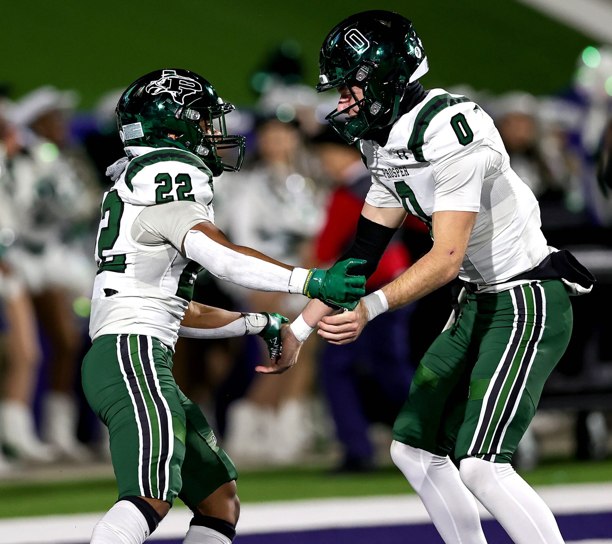 Prosper running back Leo Anguiano (22) celebrates with quarteback Nathan TenBarge (0) after...