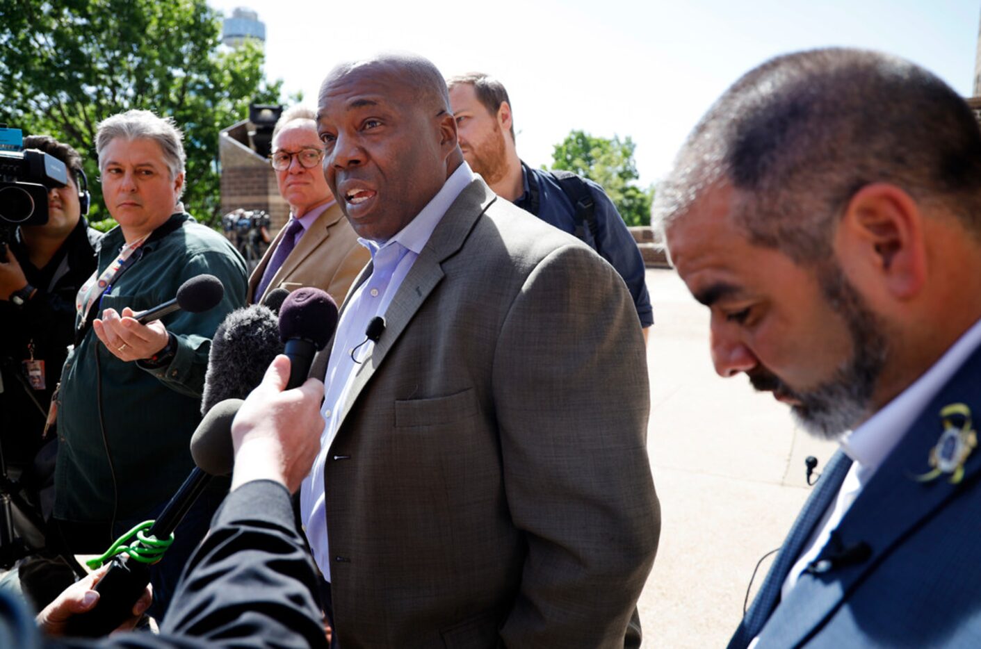 National Black Police Association's Dallas chapter president Sheldon Smith (left) supported...