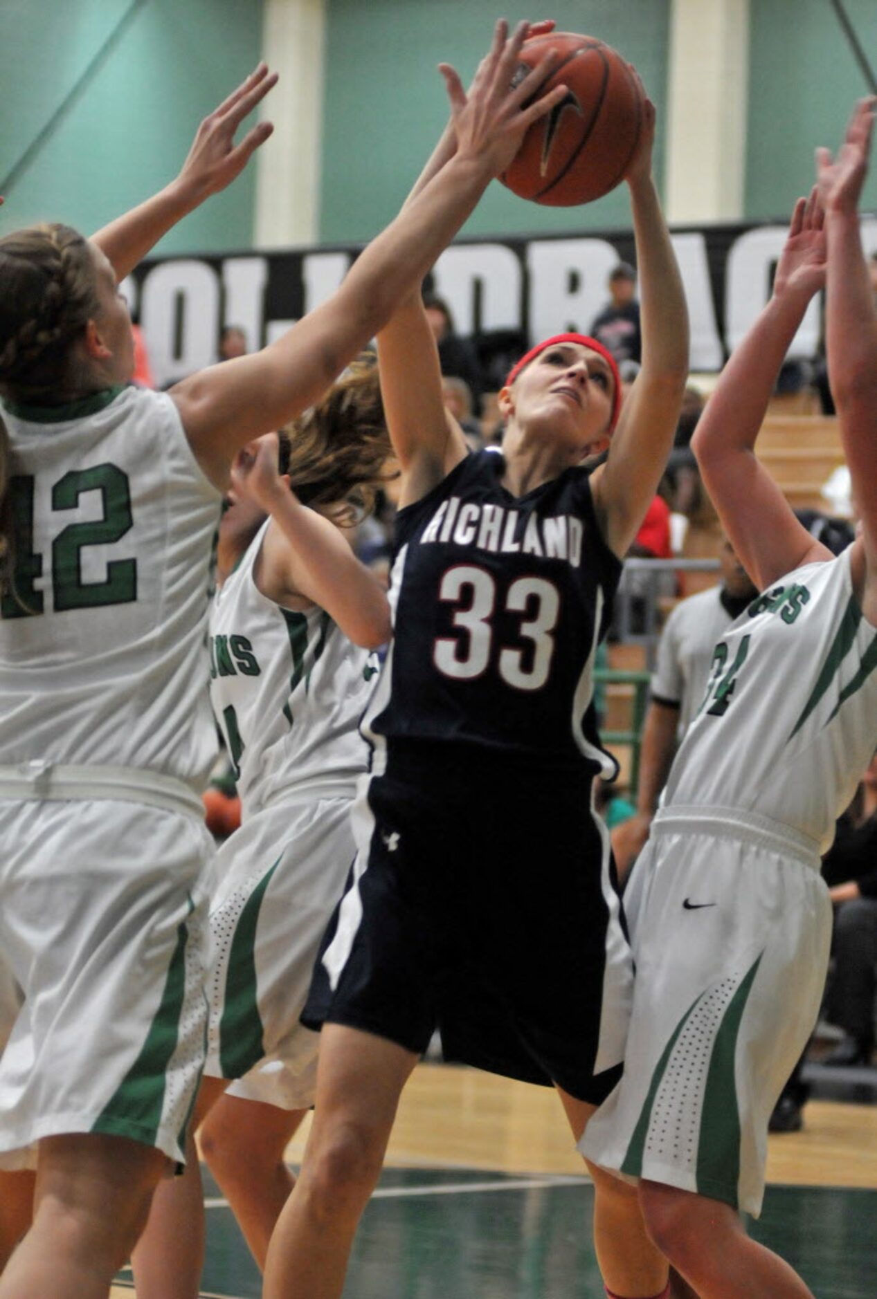 Richland senior Brooklyn Billner (33) rebounds a ball between  Carroll sophomore Madison...