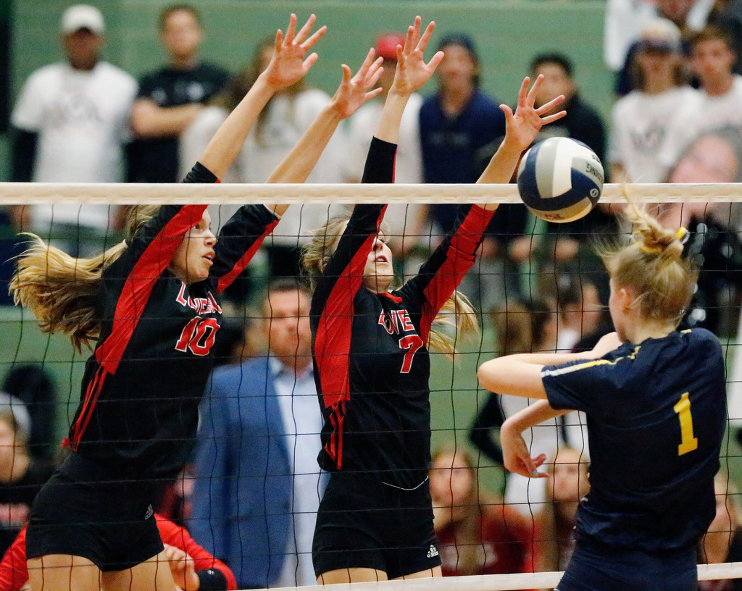 Lovejoy High School middle hitter Grace Milliken (10) and Lovejoy High School outside hitter...