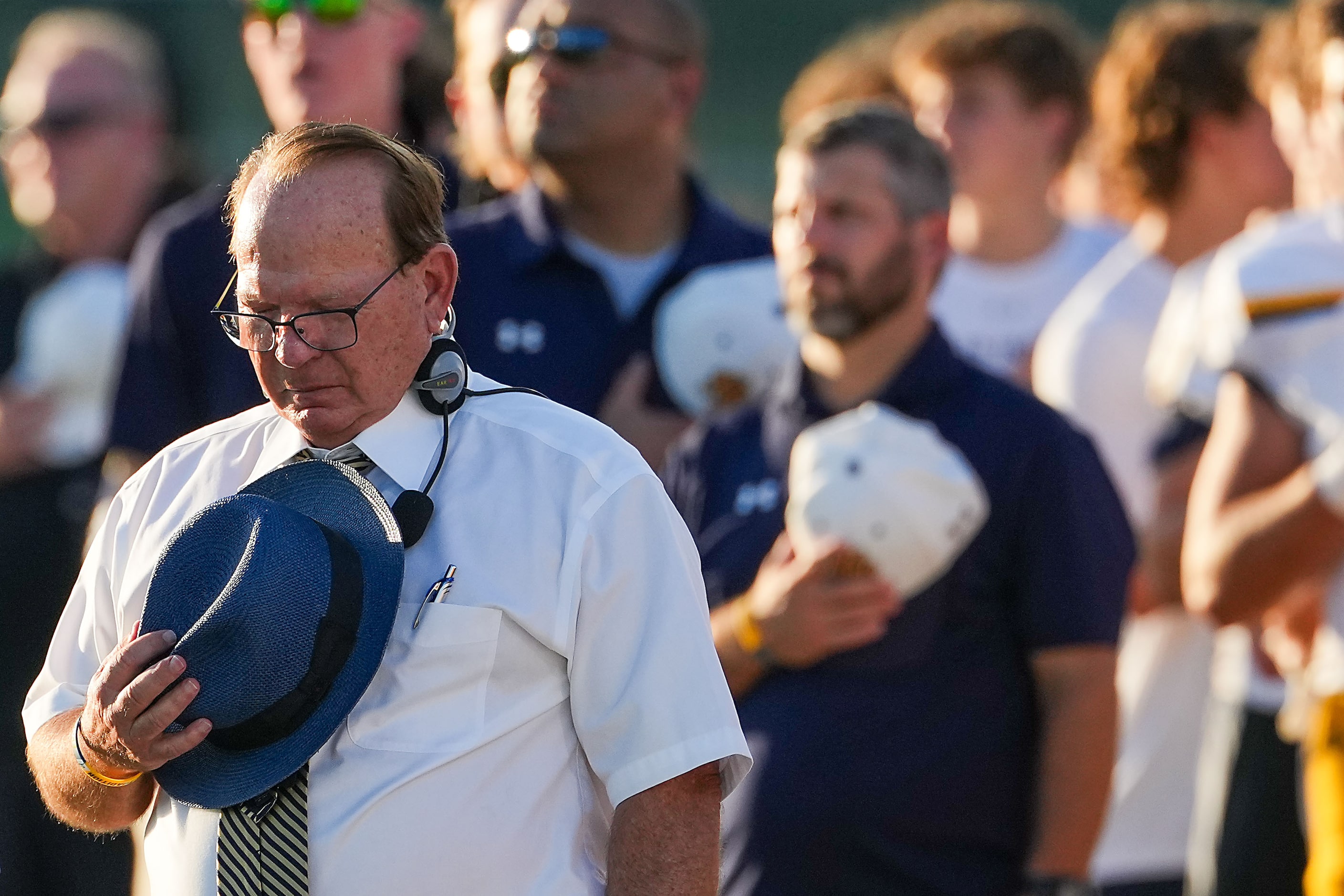 Highland Park head coach Randy Allen stands for the national anthem before the first half of...