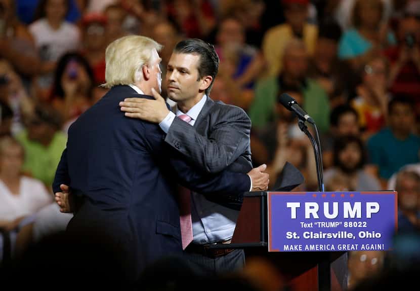Donald Trump hugs his son Donald Trump Jr. during a presidential campaign rally at Ohio...