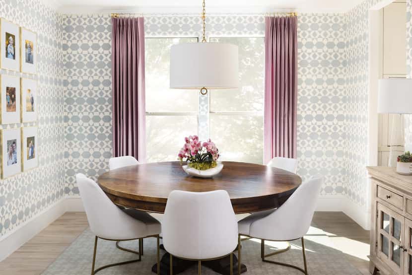 A dining room features blue geometric wallpaper and purple drapery.