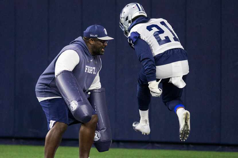 Dallas Cowboys running back Ezekiel Elliott (21) runs a drill with running backs coach Gary...