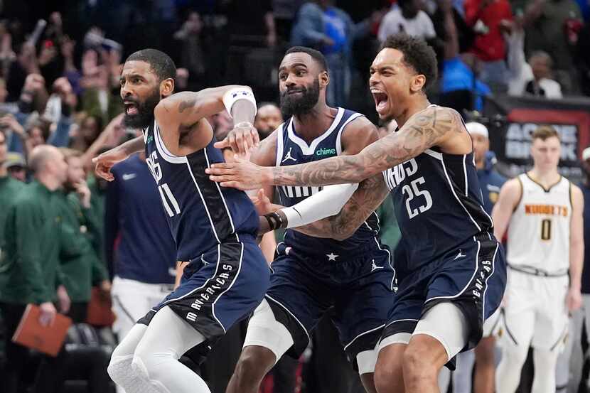 Dallas Mavericks guard Kyrie Irving (11) reacts with teammates P.J. Washington (25) and Tim...