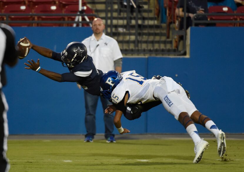 Frisco Lone Star quarterback Jason Shelley (18) lunges towards the goal line but is tackled...