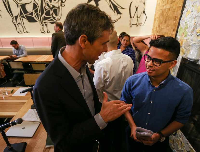 Presidential candidate Beto O'Rourke speaks with Christian Quintero, 20, following a round...