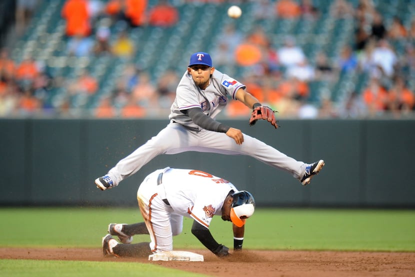 BALTIMORE, MD - JUNE 30:  Rougned Odor #73 of the Texas Rangers forces out Adam Jones #10 of...