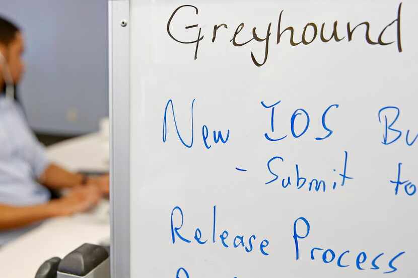 Kerde Severin, senior IOS Developer, works behind a white board at Greyhound Bus Line's new...