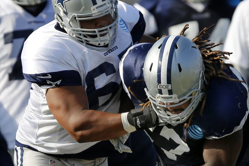 Dallas Cowboys guard Ronald Leary (65) battles defensive tackle Rodney Coe (67) in...