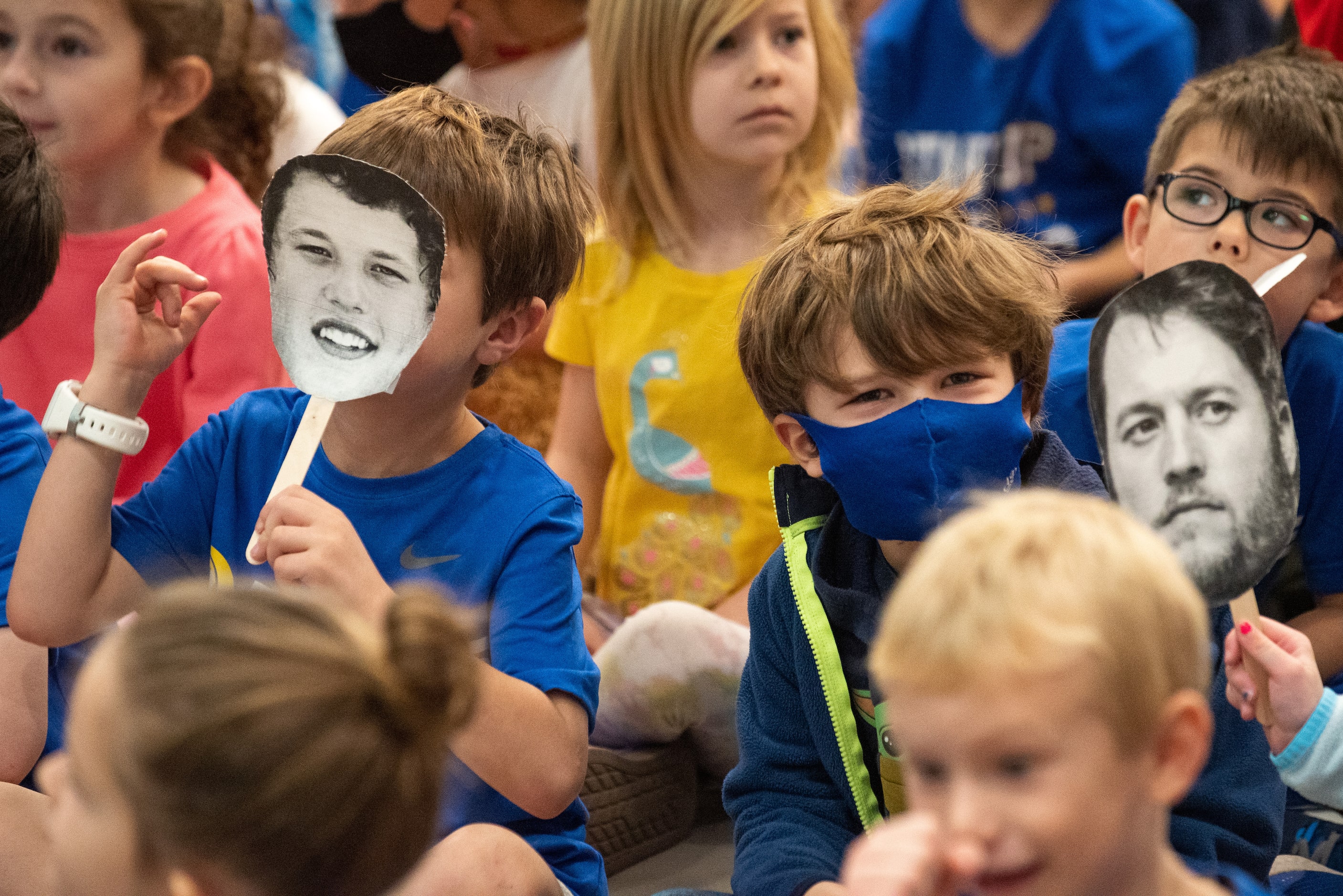 Kindergarteners William Mundinger, left, plays with a face cut-out of Los Angeles Rams QB...