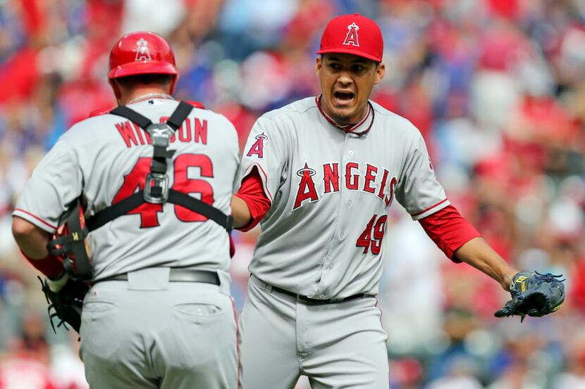 Angels' closer Ernesto Frieri (49) is congratulated by catcher Bobby Wilson (46) after...