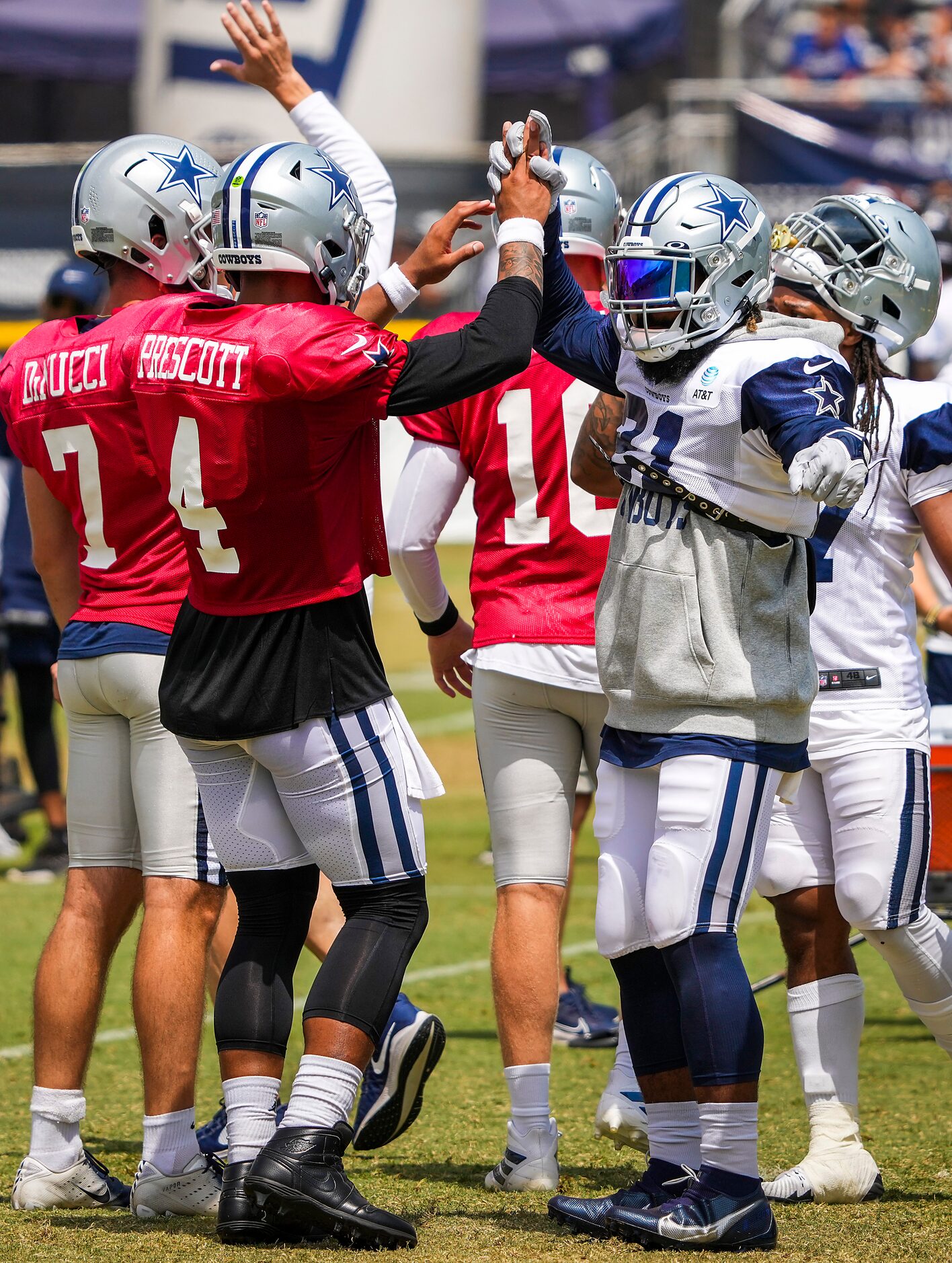 Dallas Cowboys quarterback Dak Prescott (4) high fives running back Ezekiel Elliott (21)...