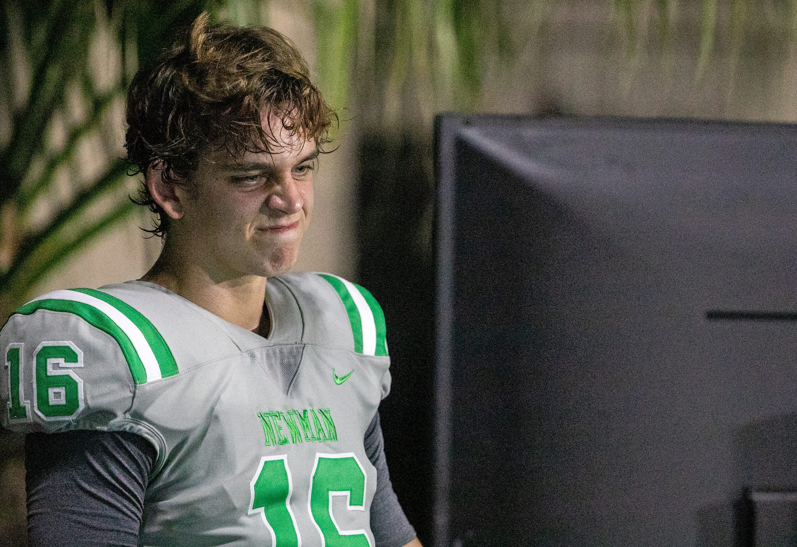 Arch Manning winces while watching replay on the sideline as Newman High School takes on...