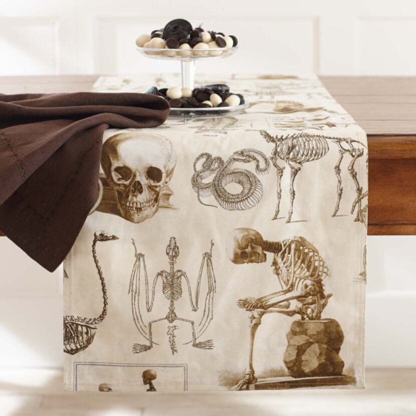 Remains of the day Skeletons of humans, reptiles and animals abound on a printed, cotton...