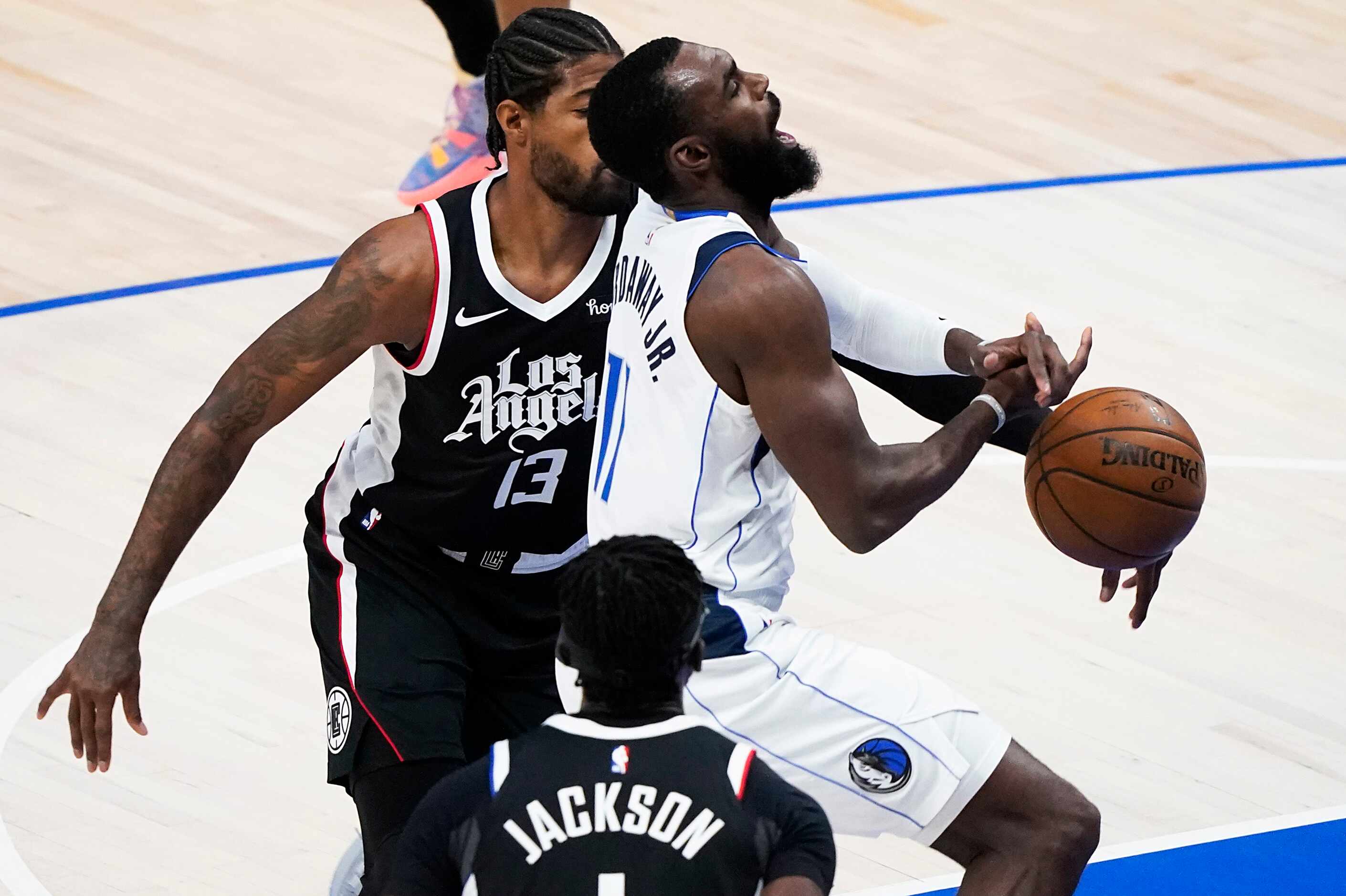 Dallas Mavericks forward Tim Hardaway Jr. (11) is fouled by LA Clippers guard Paul George...