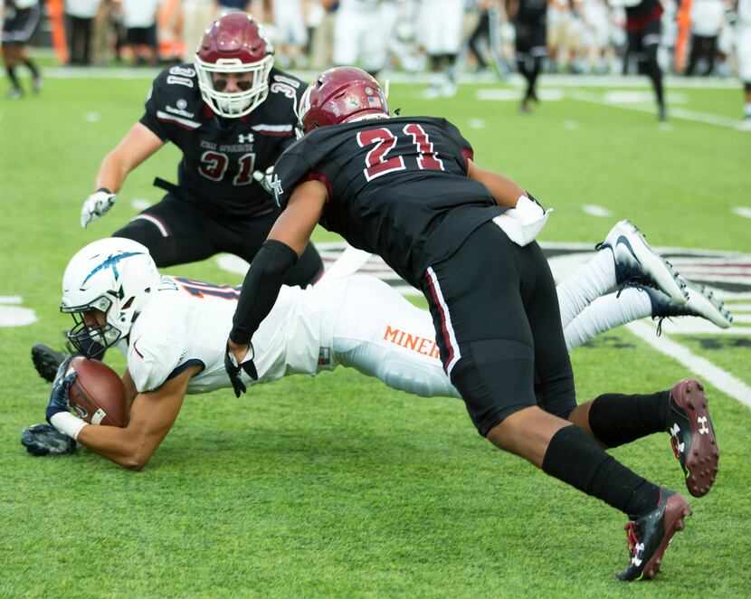 UTEP's David Lucero dives for yardage against New Mexico State during an NCAA college...