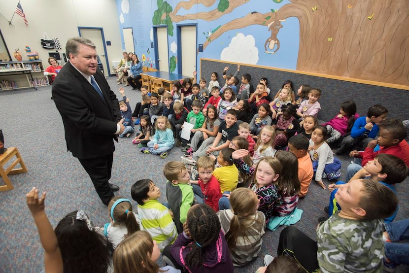 Hogue talks  with first-graders at R.F. Hartman Elementary School, where he performed a few...