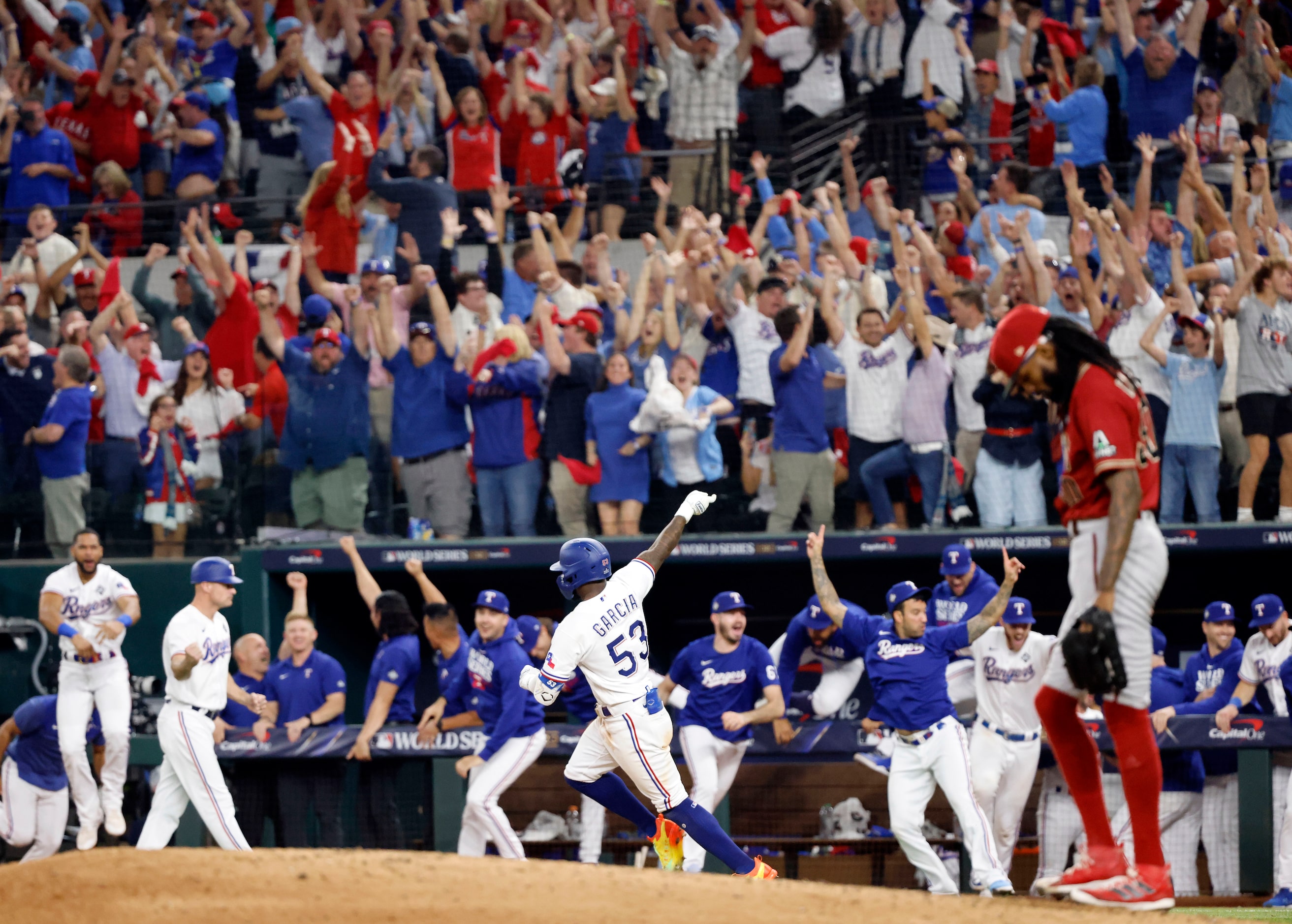 Texas Rangers Adolis Garcia (53) rounds first base after cranking a game-winning home run to...