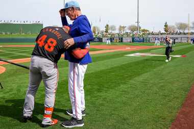 San Francisco Giants designated hitter Pablo Sandoval hugs Texas Rangers manager Bruce Bochy...