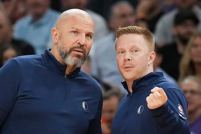 Dallas Mavericks head coach Jason Kidd (left) talks with assistant coach Sean Sweeney during...