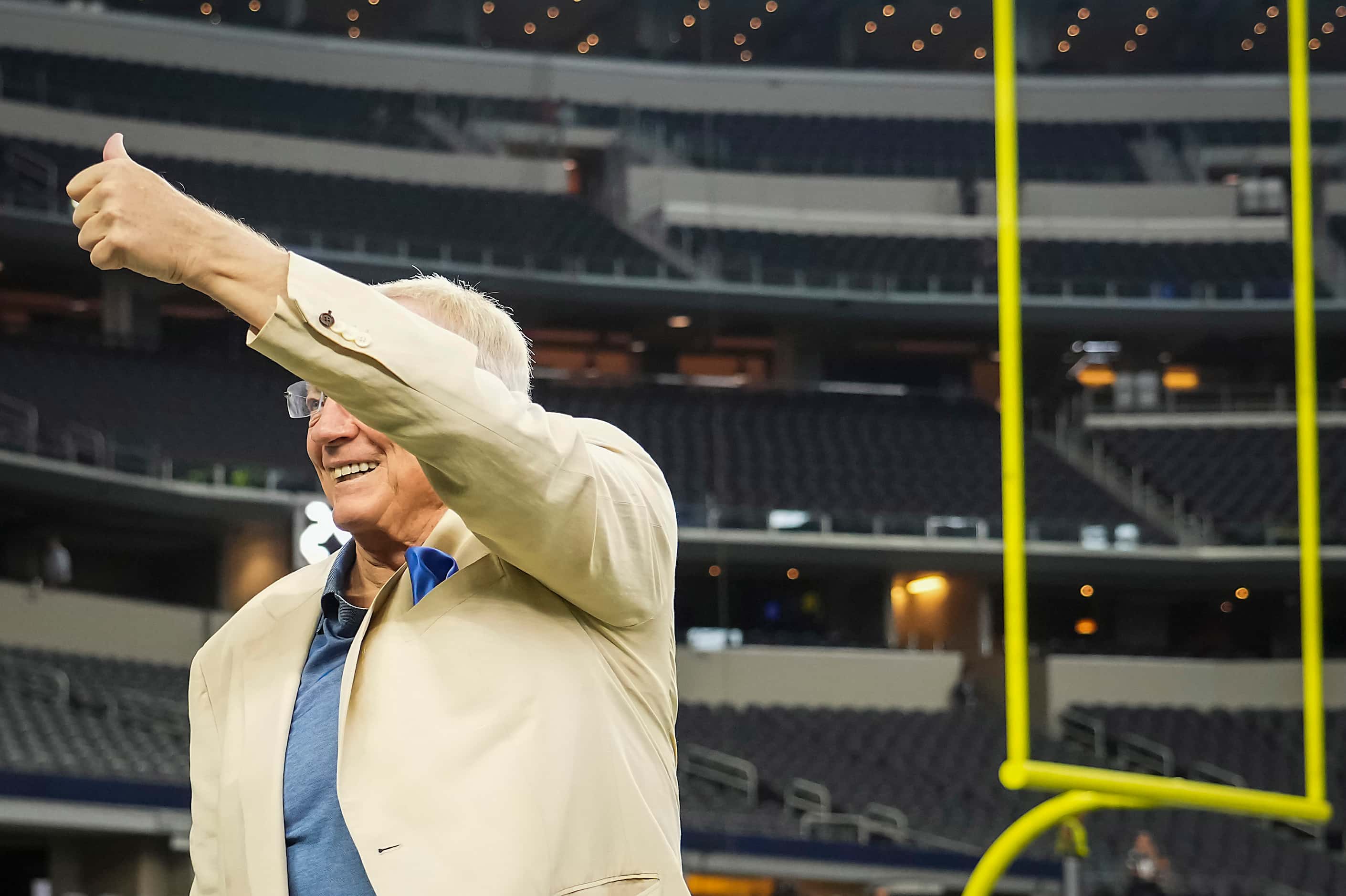 Dallas Cowboys owner and general manager Jerry Jones gives a thumbs up to the stands as...