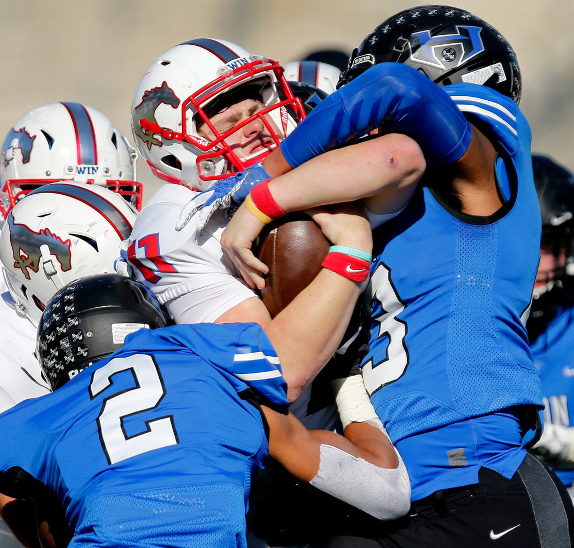 Pearce High School quarterback Bo Brewer (11) moves the pile headed up by Hebron High School...