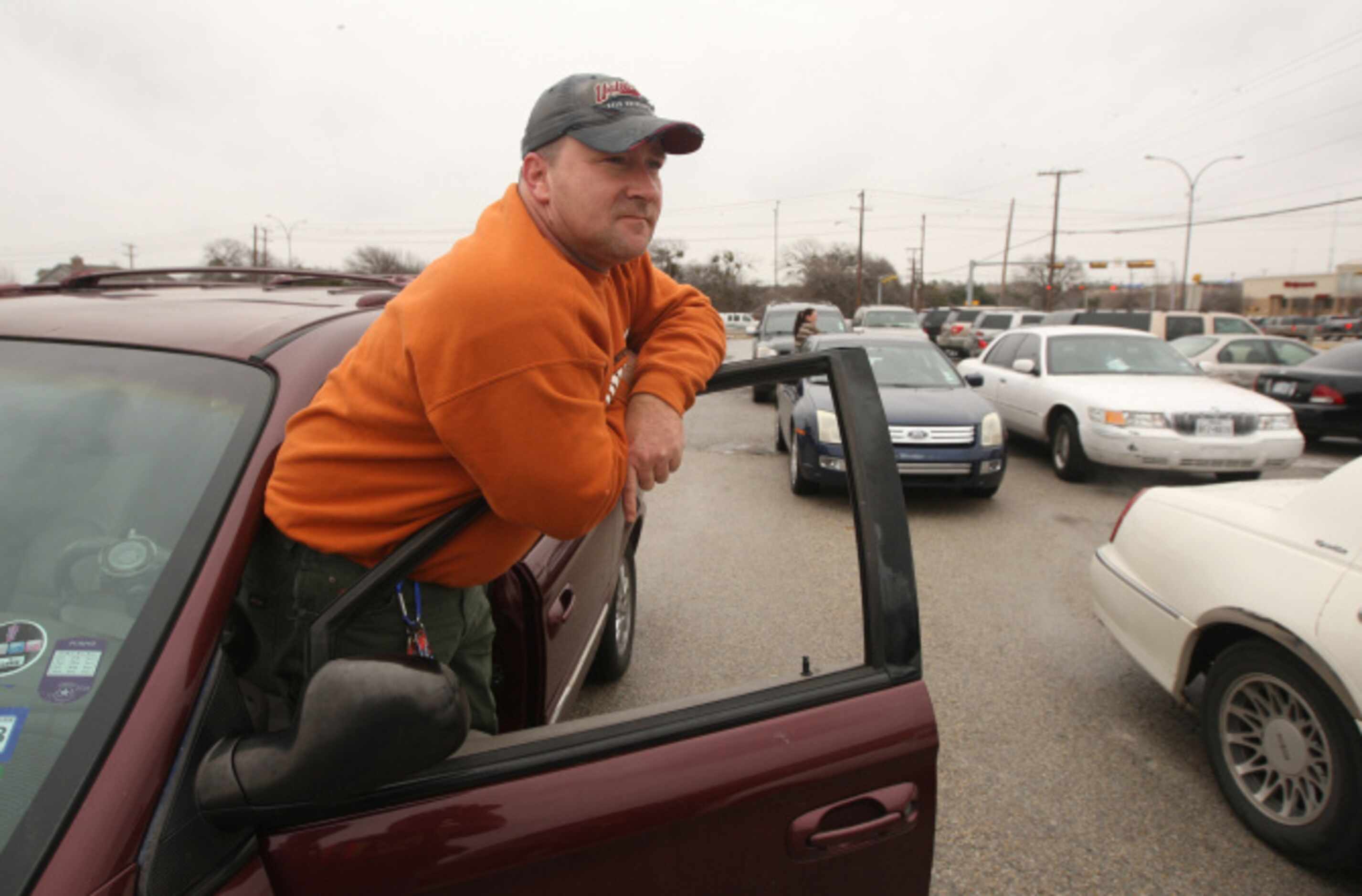 Parent Jay Brown waits with other parents during a lockdown at Arlington Lamar High School...